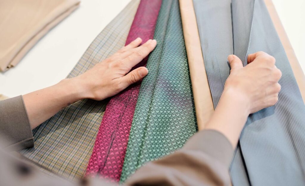 female designer looking through textiles for new c TKBQPEU