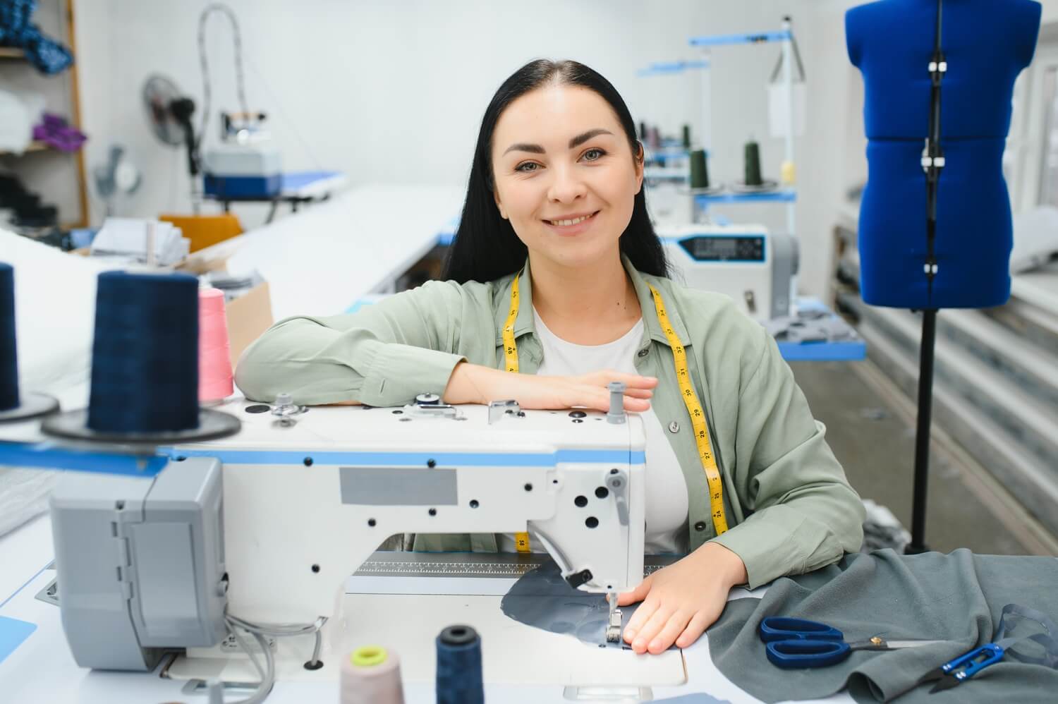 portrait of a beautiful seamstress carrying a tape CSQMUNP